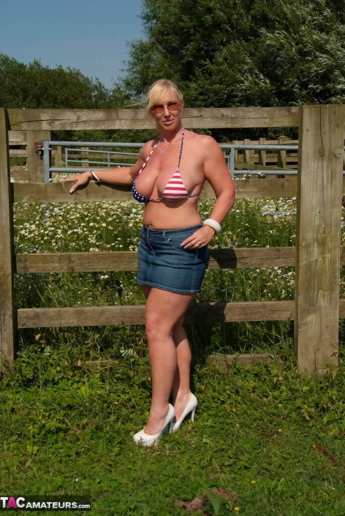 Busty mature slut Melody sheds bikini top outdoors to sun massive tits page 1