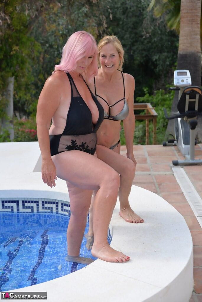 Mature blonde women frolic in a swimming pool with their swimsuits on page 1