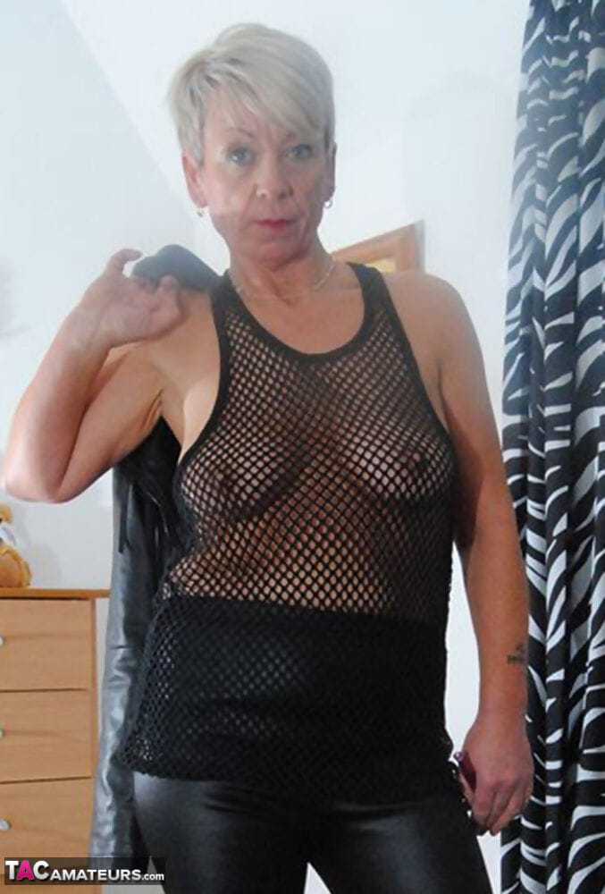 Sexy older lady frees her saggy tits and pussy from see through dress page 1