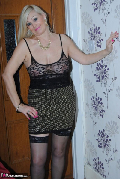 Hot mature slut Platinum Blonde showing her busty stuff in black lace lingerie