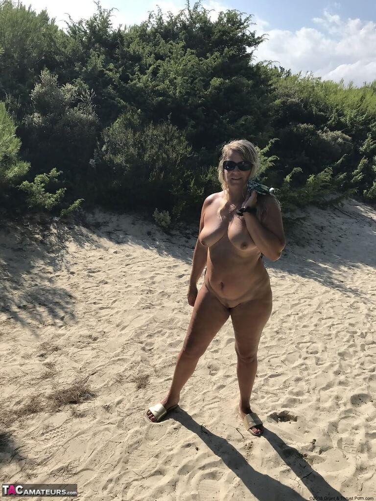 Fat amateur Sweet Susi cups her big boobs after baring her butt on sandy dune page 1