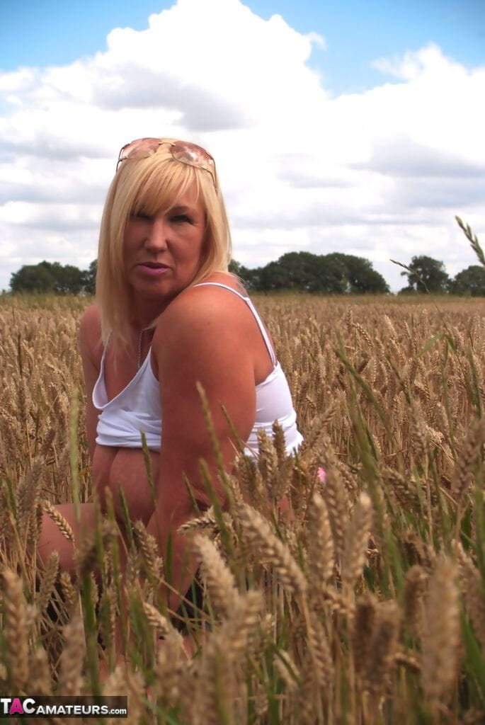 Chubby mature MILF Melody reveals great big tits & flashes hot ass in a field page 1