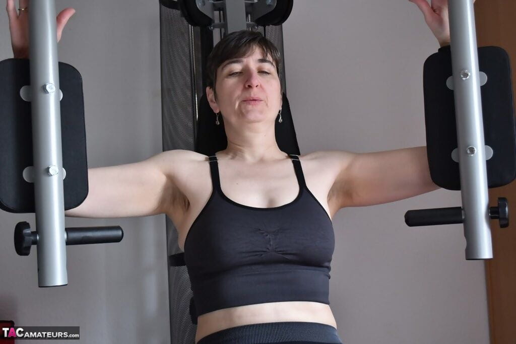 Fit older lady shows off her saggy tits while working out at the gym page 1