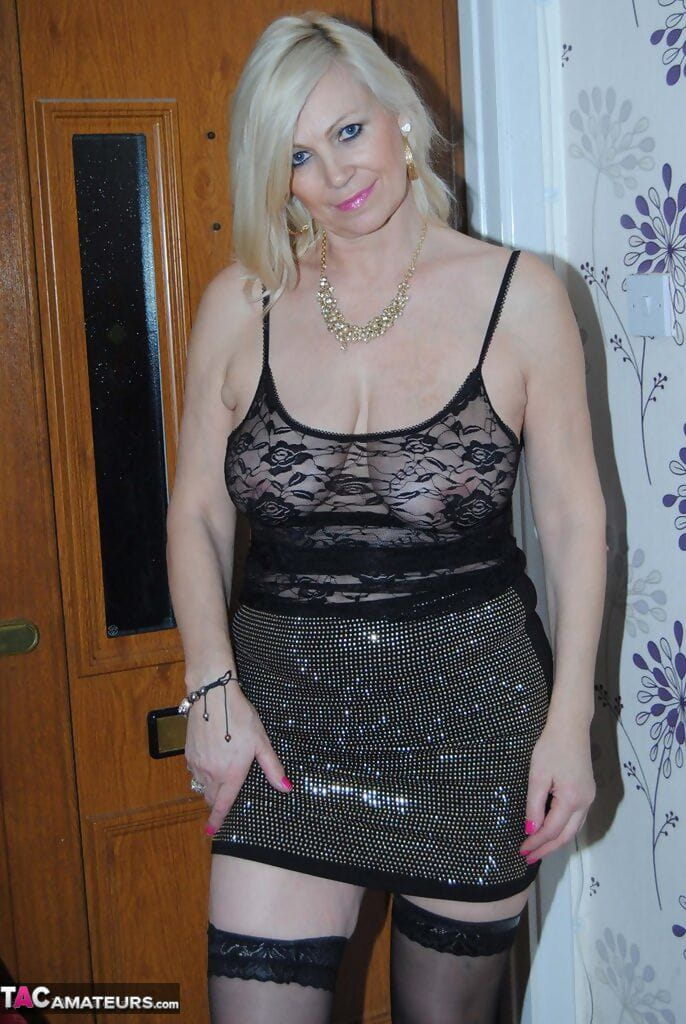 Hot mature blonde Dimonty lifts sheer lace dress to reveal big floppy tits page 1