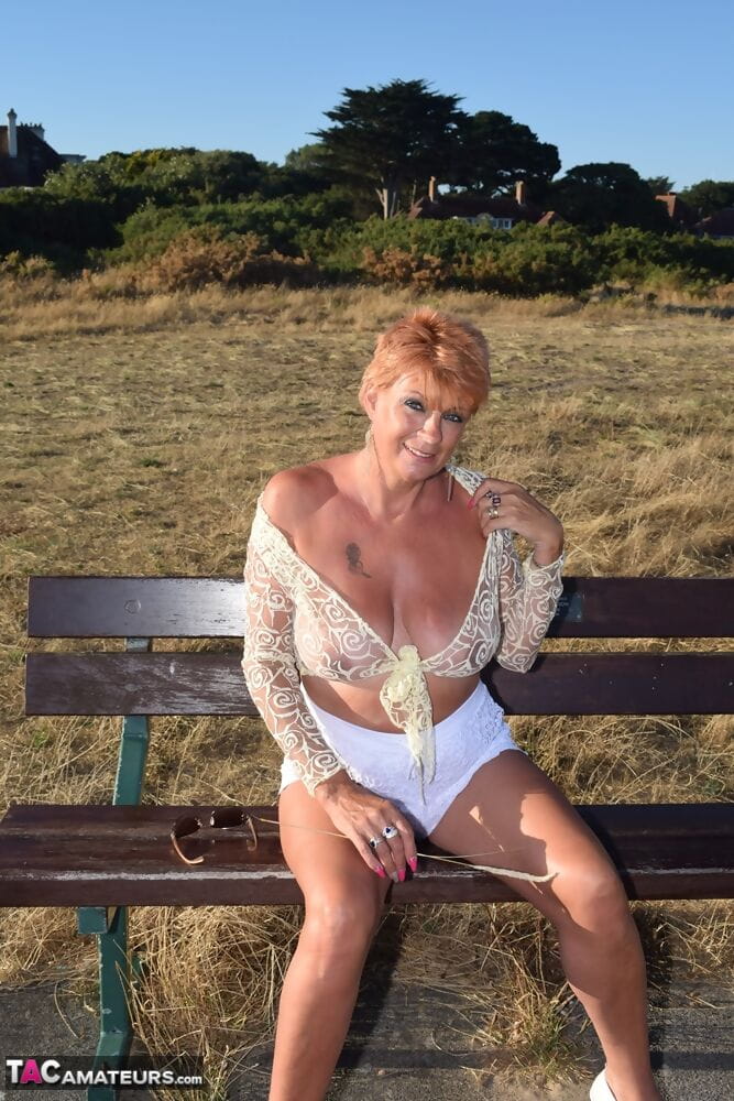 Mature woman with red hair lets her saggy tits free overlooking the ocean page 1