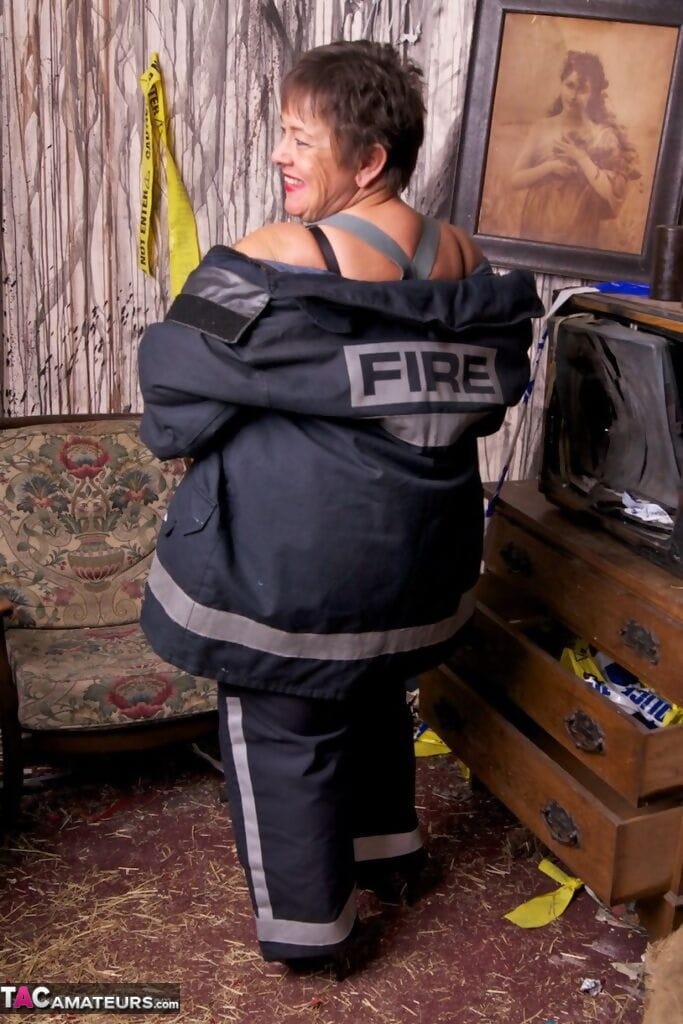 Mature fatty doffs her firefighter clothing to show her twat in stockings page 1