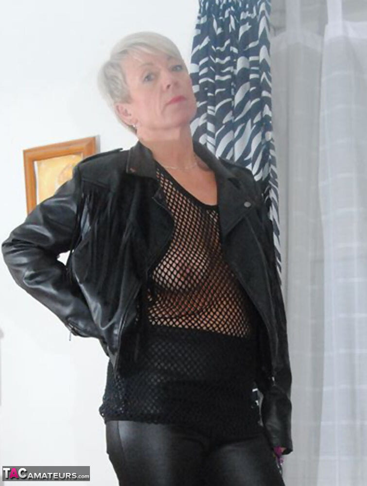Short haired nan takes off leather clothes to pose nude in mesh top page 1