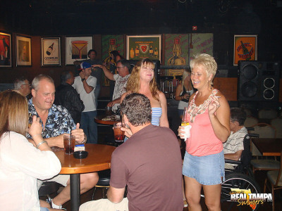 Mature swinger Tracy Lick and girlfriends seduce men at a cheap beer joint